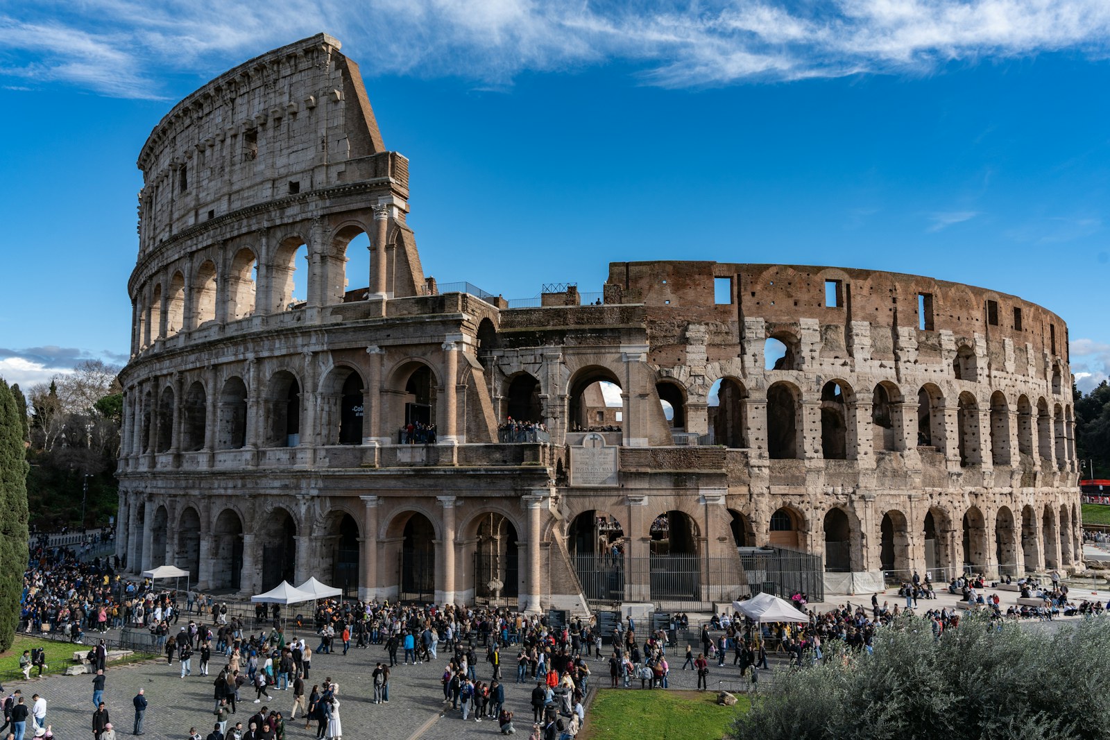 The Colosseum in Rome beneath a blue sky